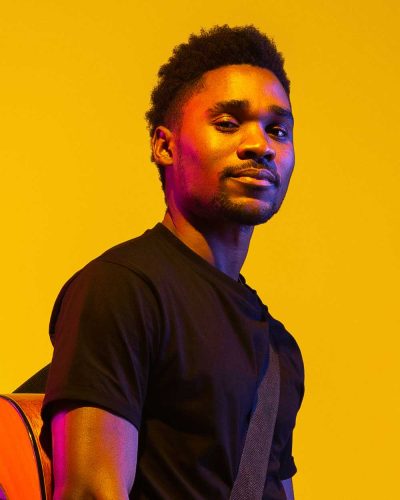 young-african-american-musician-singing-playing-gu-FSDQLP7.jpg